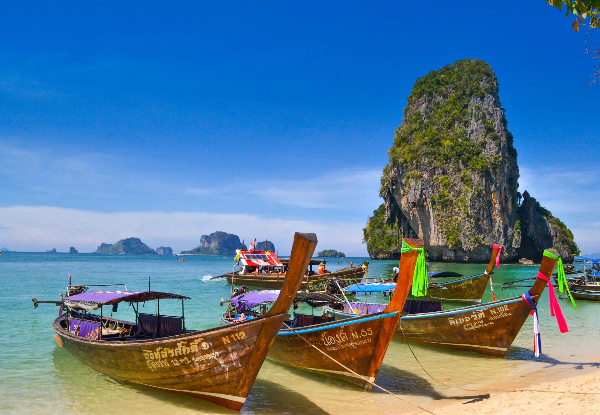 Bateau longtail entre des falaises calcaires en Thaïlande